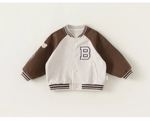 Detail of kids brown varsity jacket featuring vintage letter B embroidery and striped cuffs