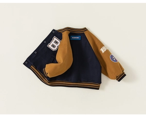 Detail of kids baseball jacket showing blue and yellow color block and varsity letter B embroidery