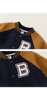 Close-up of kids baseball jacket featuring ribbed collar and B letter embroidery details