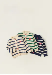 Detail of children's striped knit cardigans with red buttons and embroidered patches