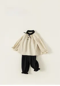 Detailed flat lay of girl's cotton linen set with puff sleeves and lantern pants