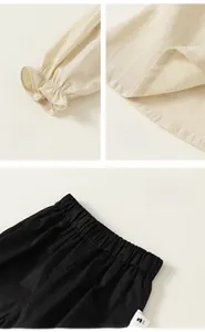 Detailed view of beige puff sleeves with lace elastic cuffs and black elastic waistband