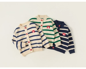 Detailed close-up of striped knit cardigans with red buttons and cartoon patches