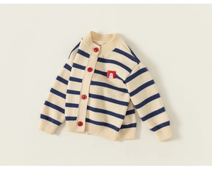 Detailed close-up of striped knit cardigan with red buttons and bird cartoon patch