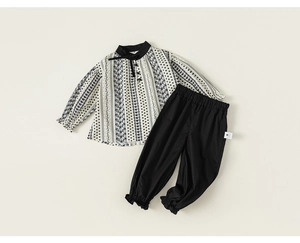 Detail of baby girl's cotton outfit with floral star print blouse and elastic black joggers