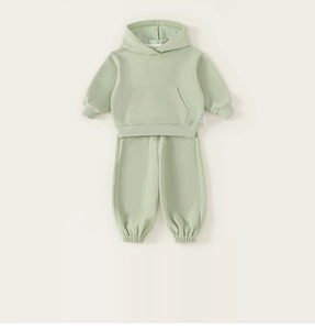 Detail view of mint green hooded sweatshirt and matching joggers set in soft cotton fabric