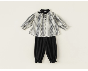 Detail of floral puff sleeve top and cinched hem pants set for young girls
