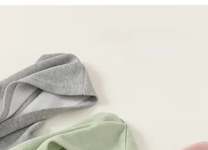 Detailed close-up showing the premium hood craftsmanship and soft knit fabric of the hoodies