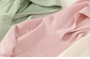 Close-up of soft ribbed fabric texture on colorful hooded sweatshirts for kids