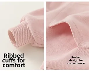 Detailed close-up of ribbed cuffs and kangaroo pocket on pink kids cotton hoodie