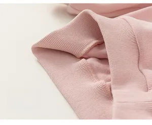 Close-up of pink hooded sweatshirt ribbed hem showing high-quality knit texture
