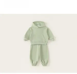 Detailed view of light green kids hoodie set with kangaroo pocket and ribbed cuffs