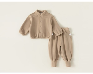 Vue détaillée à plat d'un ensemble de jogging en polaire pour enfant beige à poignets