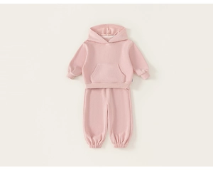 Flat lay detail of pink hooded sweatshirt and jogger pants set for children