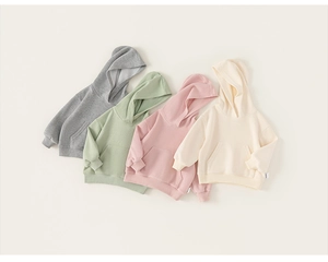 Detailed view of kids hooded sweatshirts in grey green pink and beige cotton fabric