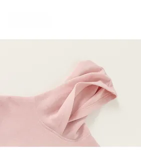 Detailed close-up of light pink ribbed knit fabric texture on a soft cotton hoodie