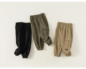 Flat lay of kids cargo pants in black, army green and khaki with elastic cuffs