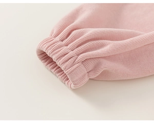 Close-up of pink knitted sweatshirt ribbed cuffs with elasticated gathered sleeve detail
