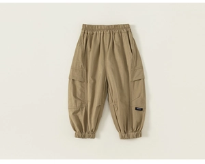 Detail of khaki kids cargo pants showing elastic waist and side pocket with label