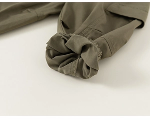 Detailed view of elastic cuffs and durable stitching on army green cargo pants