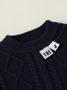 Dark blue boys cable knit sweater with ribbed crew neck and dinosaur patch detail