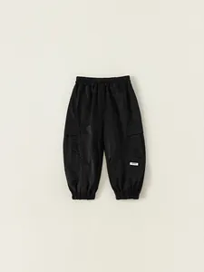 Kids black cargo pants with elastic waist and side pockets in a casual jogger style
