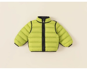 Detailed close-up of light green quilted down jacket for kids with black zipper detail
