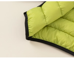 Detail of lime green quilted down jacket featuring horizontal seams and black trim edges