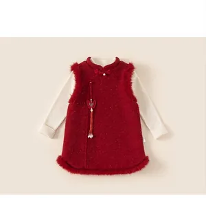 Detail of red wool vest with faux fur trim and white knitted shirt for girls