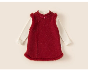 Detail of red faux fur girl's dress with pearl buttons and white knit sweater set