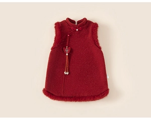 Detail of red tweed children's vest with faux fur trim, pearl buttons and tassels