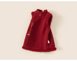 Detail of red Chinese style girls dress featuring plush edges and butterfly tassel pendant