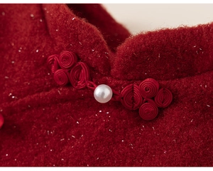Detailed macro view of red tweed qipao collar with pearl button and silver threads