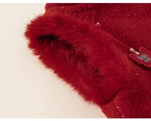 Detail of red traditional dress showing faux fur cuffs with embroidered butterfly and pearls