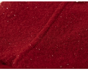 Close-up detail of dark red plush fabric with sparkling silver threads for children's dress