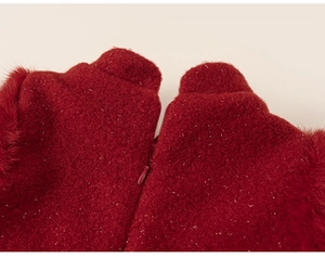 Detail of red plush fabric with silver sparkles and a hidden zipper on a girls dress