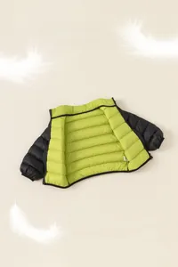 Detail of reversible lightweight down vest for kids featuring black and green contrast colors