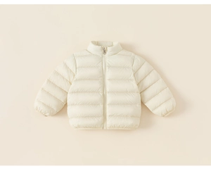 Detail of cream white quilted reversible kids down jacket with zip and ribbed cuffs