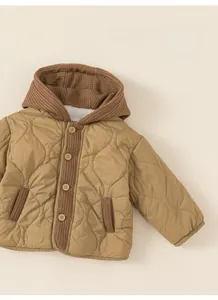 Detailed view of fleece-lined thickened interior and khaki quilted fabric on kids' coat