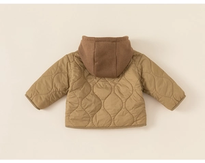 Detail of children quilted jacket featuring wavy patterns and knitted brown hood