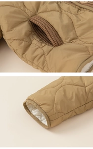 Detailed view of wave quilted fabric with ribbed knit pocket and warm fleece lining
