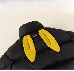 Detail of children's quilted puffer jacket featuring yellow bunny ear design on the back