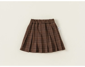 Close-up of girls' brown plaid pleated skirt featuring elastic waist and tartan pattern