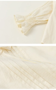 Detail of ruffled cuffs and pintuck craftsmanship on cream knit cardigan for girls