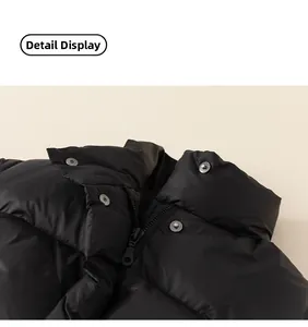 Detail view of puffer jacket stand collar with black zipper and silver metal snap buttons