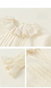 Detail showing elegant lace embroidery collar and pleated front on a girl shirt