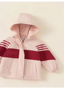 Detail of color-block hooded winter coat with pink and burgundy panels and stripe sleeves