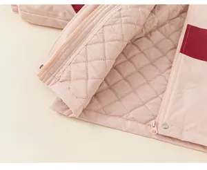 Close-up of pink quilted lining with thick padding and color-block jacket details