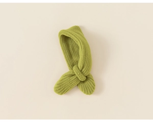 Close-up of grass green knitted kids scarf featuring vertical rib patterns and cross design