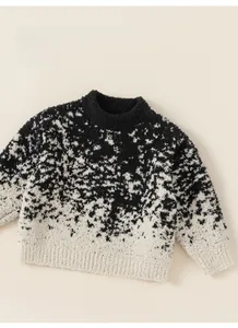 Detailed close-up of thickened marble pattern knit sweater with ribbed cuffs and hem